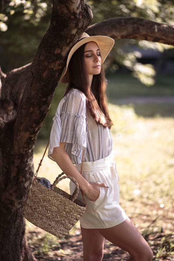 Pretty Young Woman in a Summer Garden, Casual Romantic Style with Hat ...