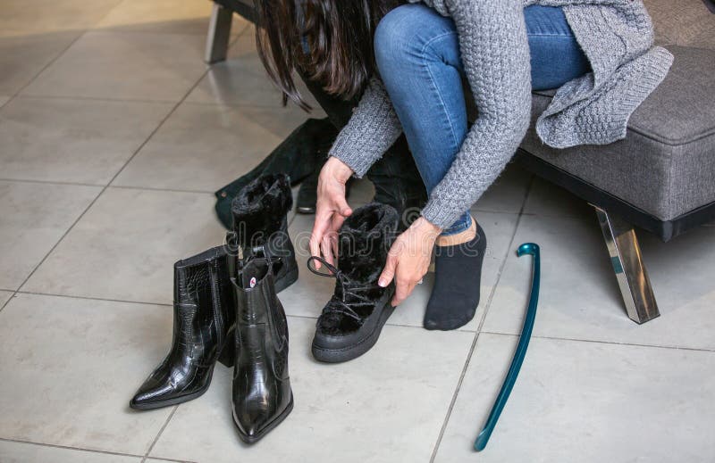 Pretty Young Woman Trying and Choosing the Right Shoes or Boots in the ...