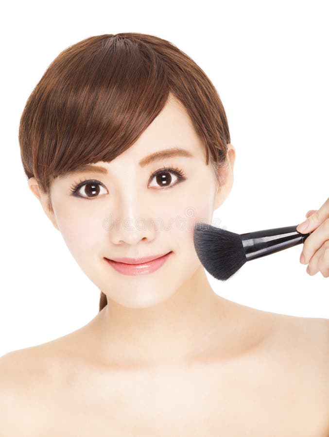Pretty young woman using brushes makeup her face stock photography Pretty young woman using brushes makeup her face stock photography