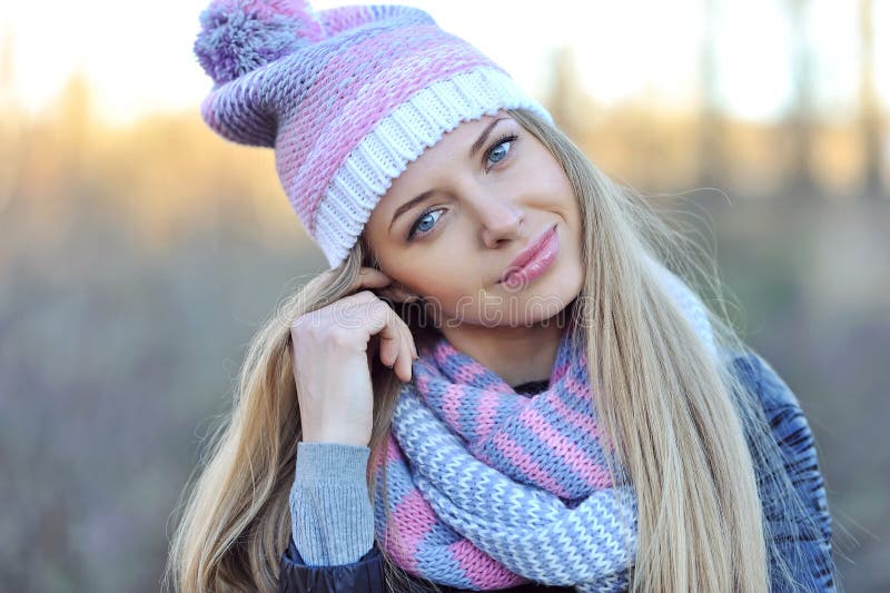 Pretty young woman wearing hat and scarf. Close up