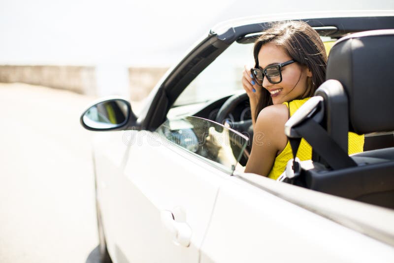 Pretty young woman in white cabriolet car royalty free stock photo Pretty young woman in white cabriolet car royalty free stock photo