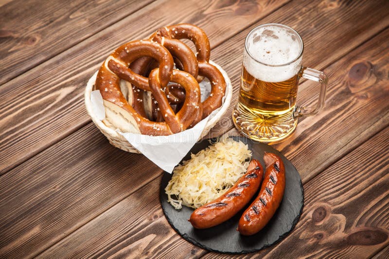 Pretzels, Bratwurst and Sauerkraut on Wooden Table Stock Photo - Image ...