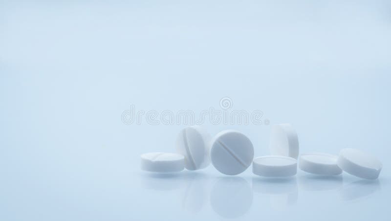 7 white round tablets pill on white background with beautiful and unique pattern with copy space. Global healthcare concept. Background for pharmacy drugstore. Pharmaceutical industry. 7 white round tablets pill on white background with beautiful and unique pattern with copy space. Global healthcare concept. Background for pharmacy drugstore. Pharmaceutical industry.