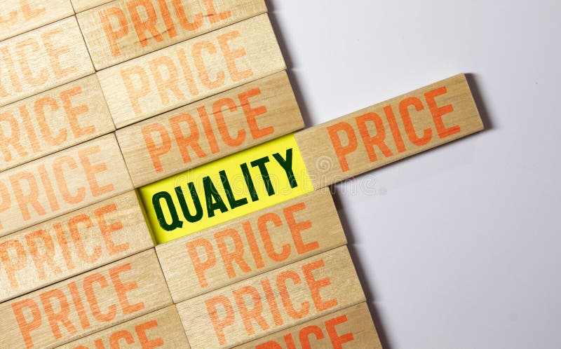 Price versus Quality. The cube with the word quality is selected by a hand. Price versus Quality. The cube with the word quality is selected by a hand