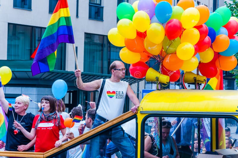 Pride Parade Event in Action. Proud Man with Rainbow Flag in His Raised