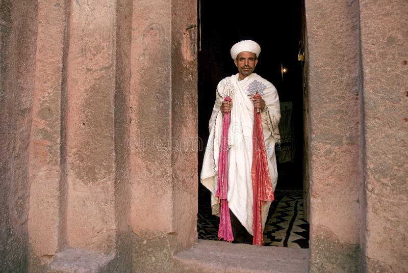 Priest in Bet Danaghel Church holding the Cross of King Lalibela. The  rock-hewn churches of Lalibela make it one of the greatest  Religio-Historical sites not only in Africa but in the Christian