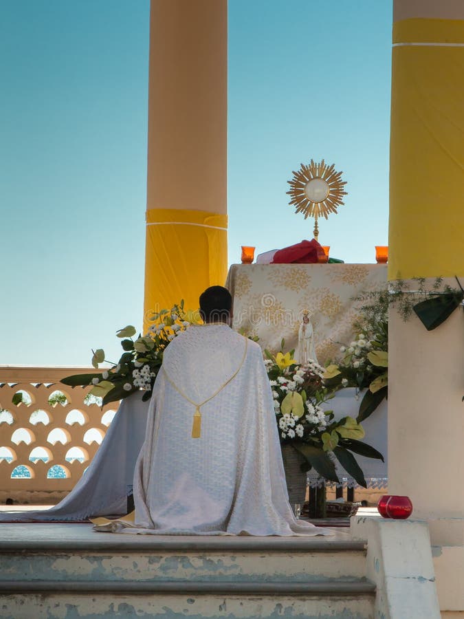 Priest Kneel Down in front of an Altar: Outdoor Church
