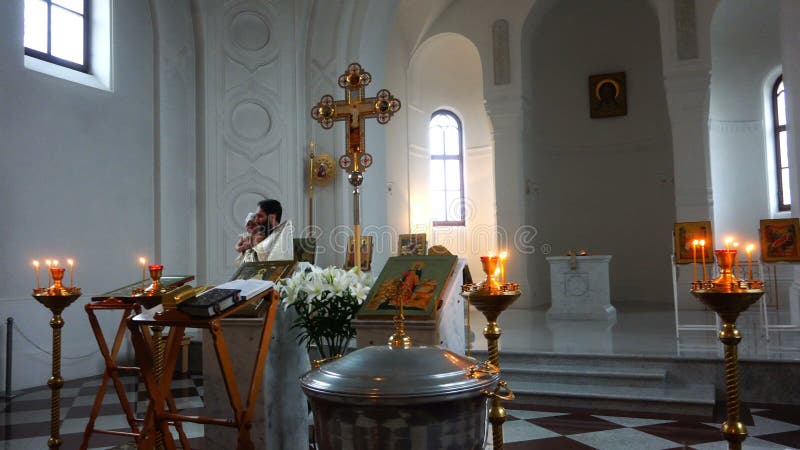 The priest performs a sacred rite in the church