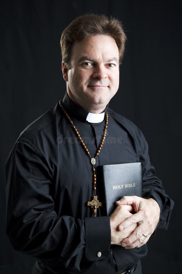 Portrait of a priest with a rosary and a bible. Dramatic lighting over black background. Portrait of a priest with a rosary and a bible. Dramatic lighting over black background.