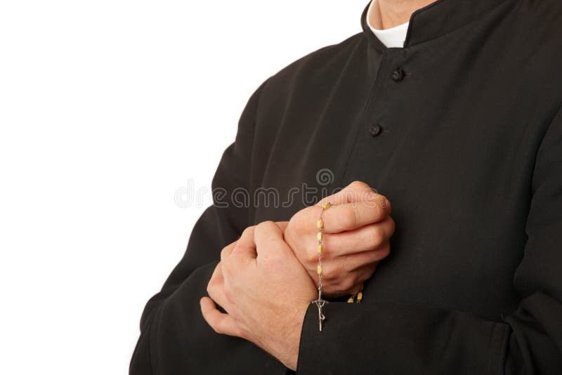 Priest's hands with rosary stock photo