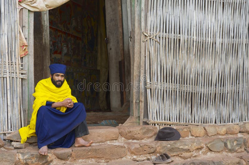 Priest sits at the entrance to the ancient church Ura Kidane Mehret in Bahir Dar, Ethiopia.