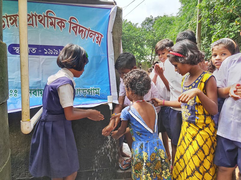 primary school students are washing their hand and their dishes before taking Mid-day meal in a primary school of West Bengal royalty free stock photography primary school students are washing their hand and their dishes before taking Mid-day meal in a primary school of West Bengal royalty free stock photography