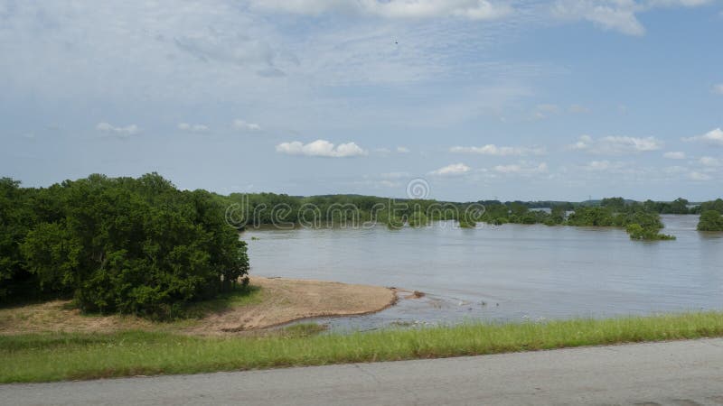 The Arkansas River is expected to reach historic levels after an extremely wet spring through Kansas and Oklahoma in the spring of 2019. View from Highway 59 looking downstream towards the east, water covering fields. The Arkansas River is expected to reach historic levels after an extremely wet spring through Kansas and Oklahoma in the spring of 2019. View from Highway 59 looking downstream towards the east, water covering fields