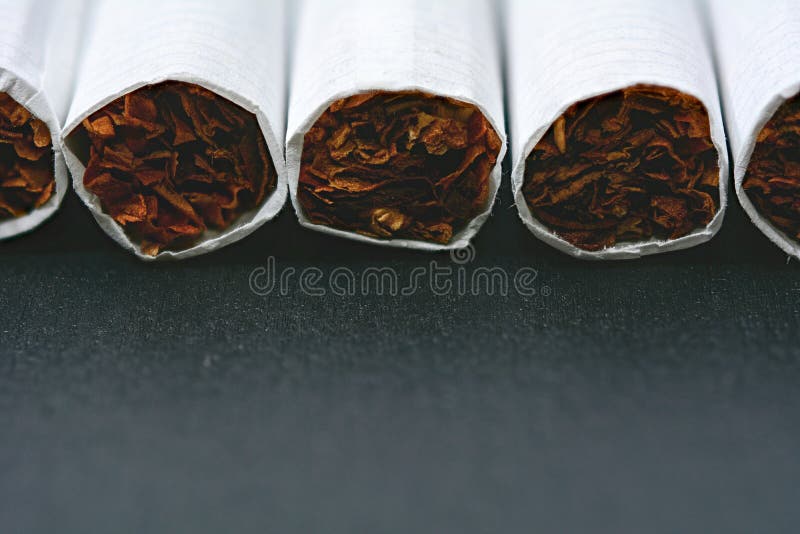 Closeup of cigarettes on black wooden table. Closeup of cigarettes on black wooden table