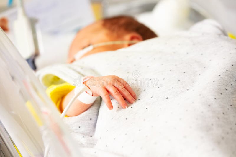 Close up of little premature born infant hand with heart rate monitor in hospital. Close up of little premature born infant hand with heart rate monitor in hospital