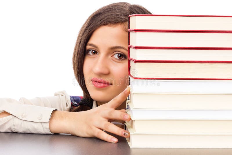 Closeup of student face behind stack of books isolated over white background. Closeup of student face behind stack of books isolated over white background