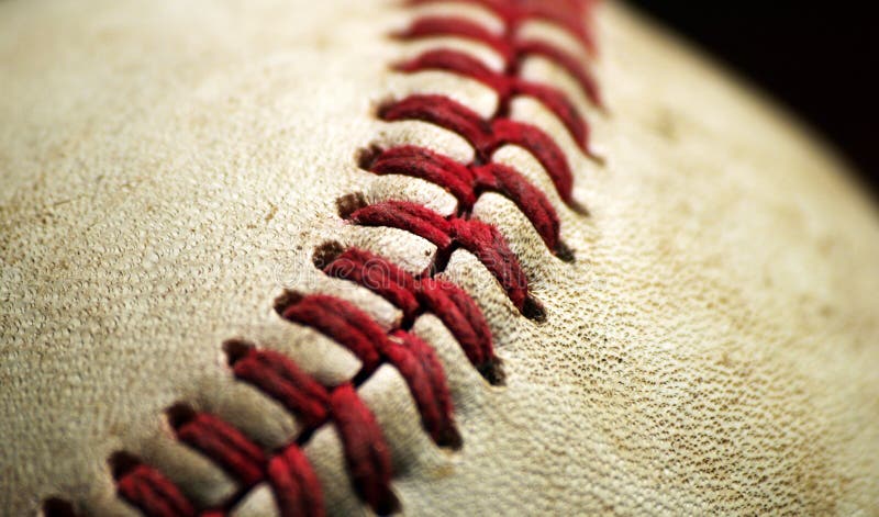 A Baseball Macro Closeup with black background. A Baseball Macro Closeup with black background.