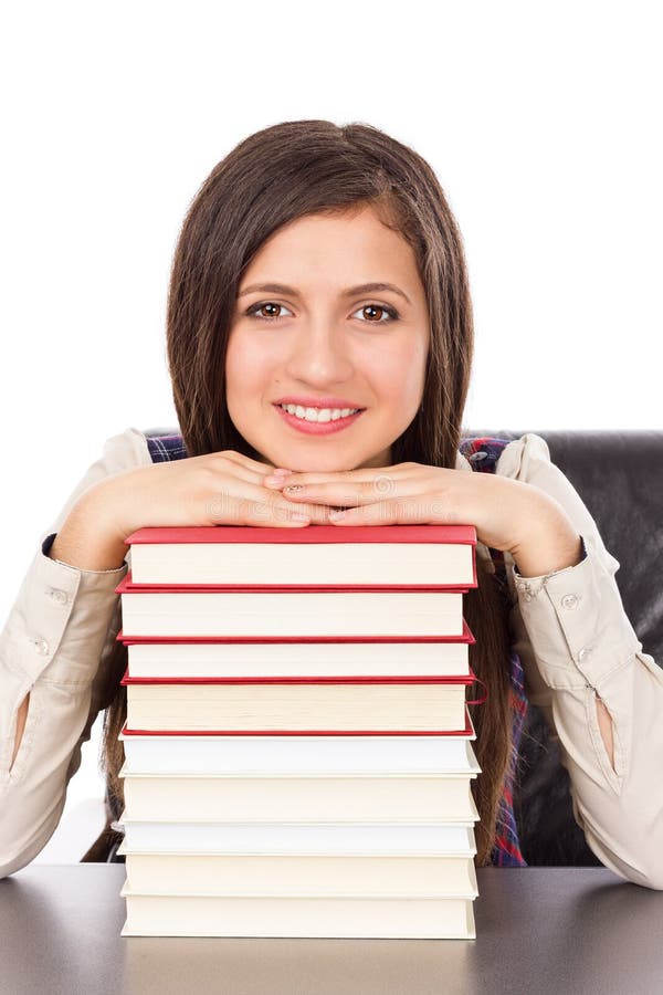 Closeup of student holding her head on a stack of books isolated over white background. Closeup of student holding her head on a stack of books isolated over white background