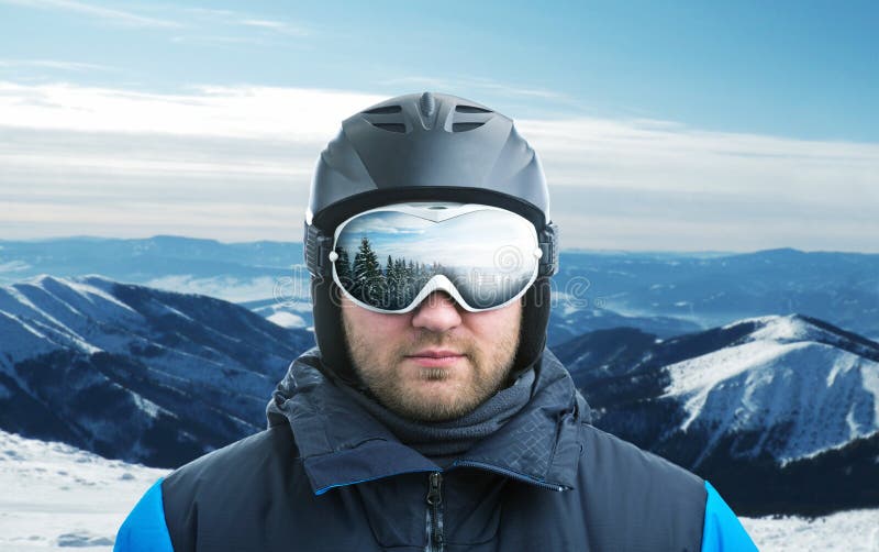 Mountain-skier against mountain with reflection in googles. Mountain-skier against mountain with reflection in googles