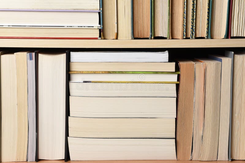 Closeup of a large group of used books on a bookshelf. Closeup of a large group of used books on a bookshelf.