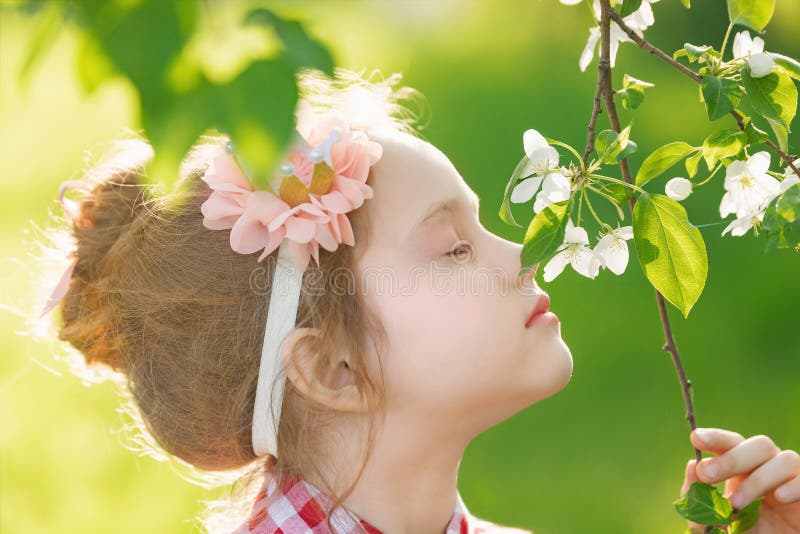 Princess girl breathing a apple flower in sunset light, profile stock images