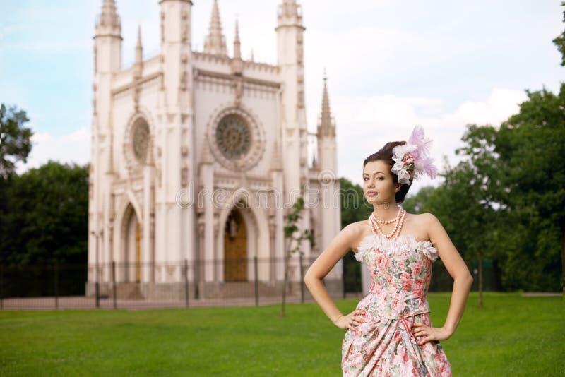 Princess in an vintage dress before castle