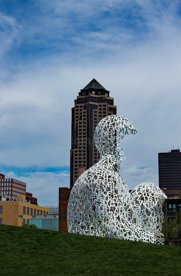 The image is the view of Des Moines as seen from the Pappajohn Sculpture Park. 801 Grand, also known as the Principal Building, towers over the rest of the cityscape. In the Foreground, the sculpture Nomade by Jaume Plensa contrasts with the dark buildings behind it. This image captured with a Canon T3i and 18-55mm lens in Pappajohn Sculpture Park, Des Moines, Iowa on April 24, 2016. The image is the view of Des Moines as seen from the Pappajohn Sculpture Park. 801 Grand, also known as the Principal Building, towers over the rest of the cityscape. In the Foreground, the sculpture Nomade by Jaume Plensa contrasts with the dark buildings behind it. This image captured with a Canon T3i and 18-55mm lens in Pappajohn Sculpture Park, Des Moines, Iowa on April 24, 2016.