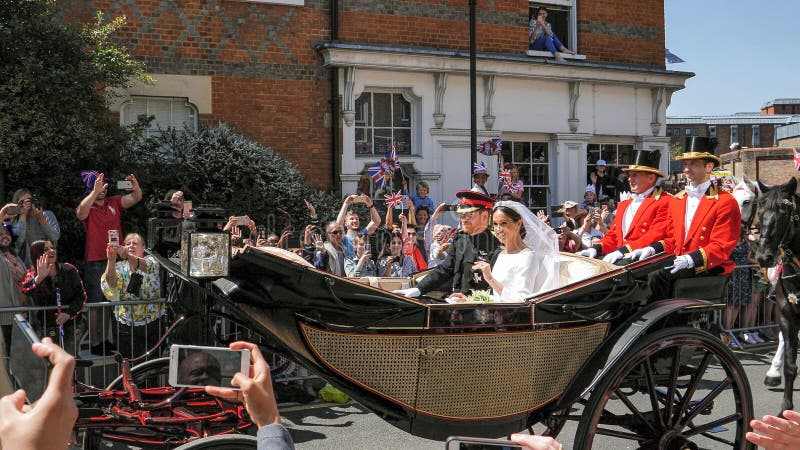 WINDSOR, ENGLAND - MAY 19 2018: Prince Harry, Duke of Sussex and Meghan, Duchess of Sussex leave Windsor Castle in Ascot Landau carriage during a procession after getting married at St Georges Chapel. WINDSOR, ENGLAND - MAY 19 2018: Prince Harry, Duke of Sussex and Meghan, Duchess of Sussex leave Windsor Castle in Ascot Landau carriage during a procession after getting married at St Georges Chapel