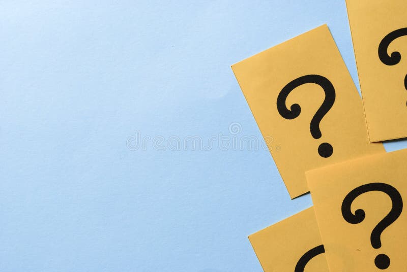 Printed question marks on yellow paper or card royalty free stock photo