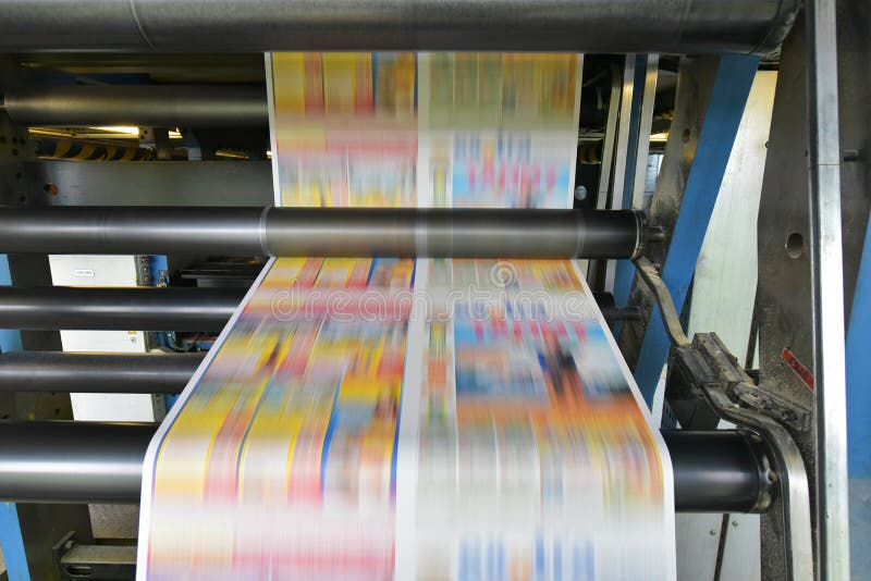 Printing of coloured newspapers with an offset printing machine at a printing press company royalty free stock image