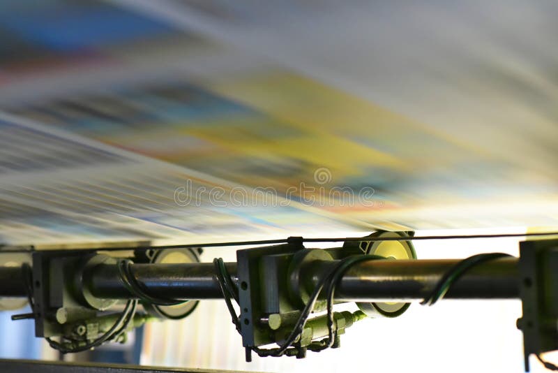 Printing of coloured newspapers with an offset printing machine at a printing press company royalty free stock images