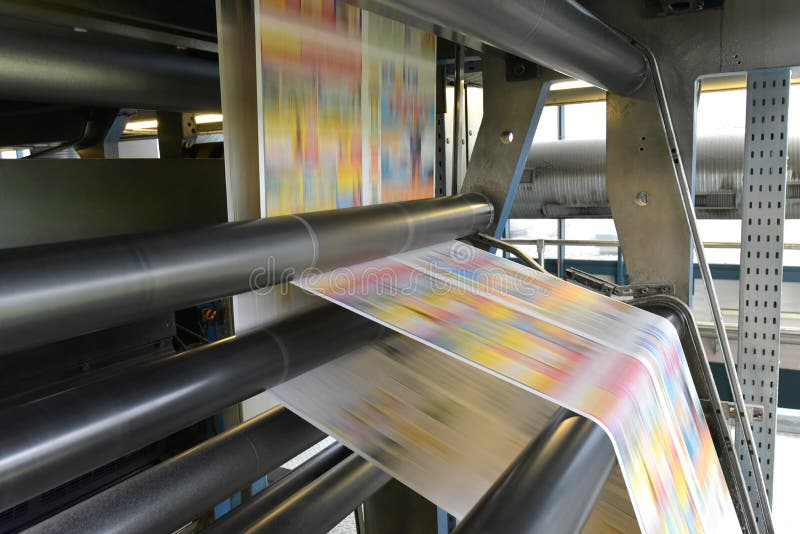 Printing of coloured newspapers with an offset printing machine at a printing press company royalty free stock photo