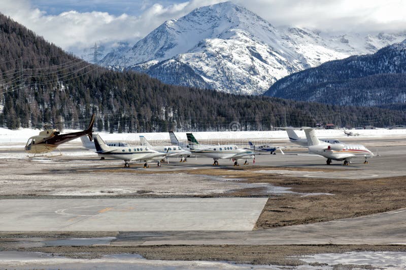 Private jets and a helicopter at the airport of St Moritz stock photography Private jets and a helicopter at the airport of St Moritz stock photography