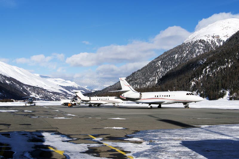 Private jets and planes in the airport of St Moritz Switzerland in winter time royalty free stock photo Private jets and planes in the airport of St Moritz Switzerland in winter time royalty free stock photo