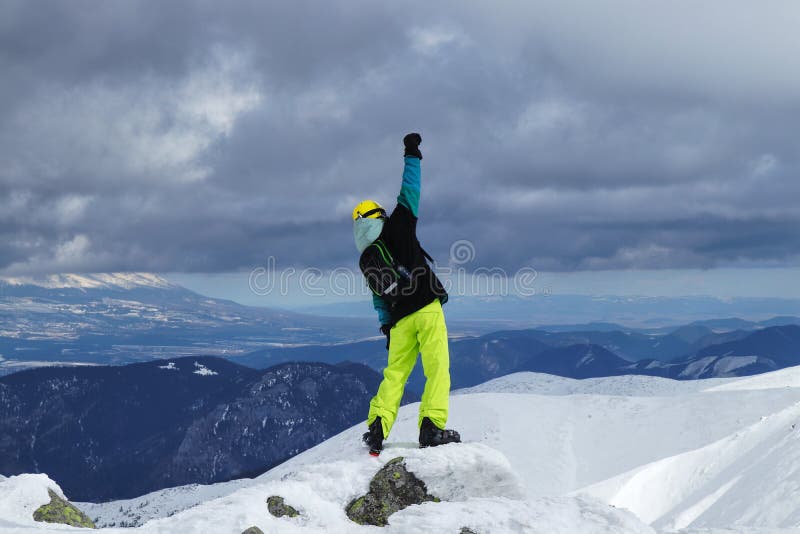 Pro climber has reached his goal. Free rider celebrate on the top of mountain in Low Tatras, Slovakia. The concept of extreme