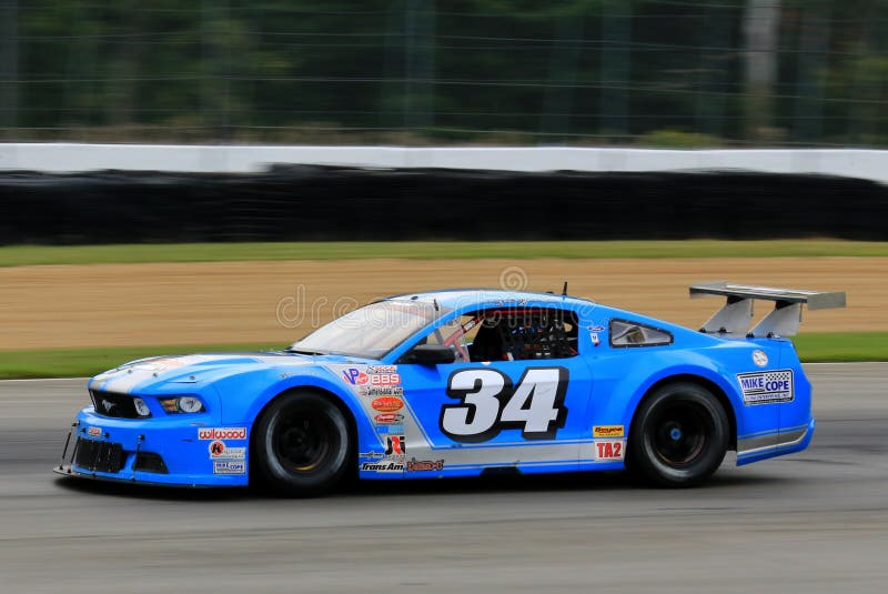 Pro Ford Mustang race car on the course