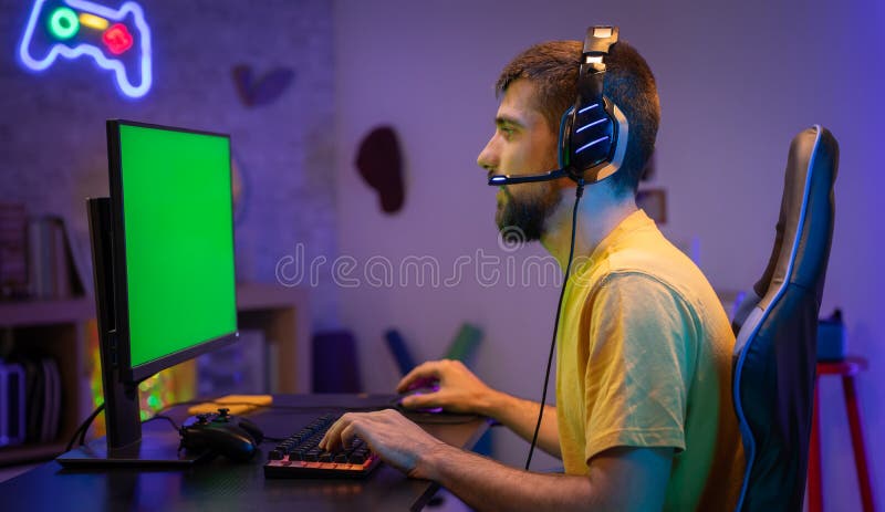 Free Photo  Player winning video games with controller and headset in  front of monitor. man using joystick and headphones, playing online games  on computer. person celebrating game win for leisure.