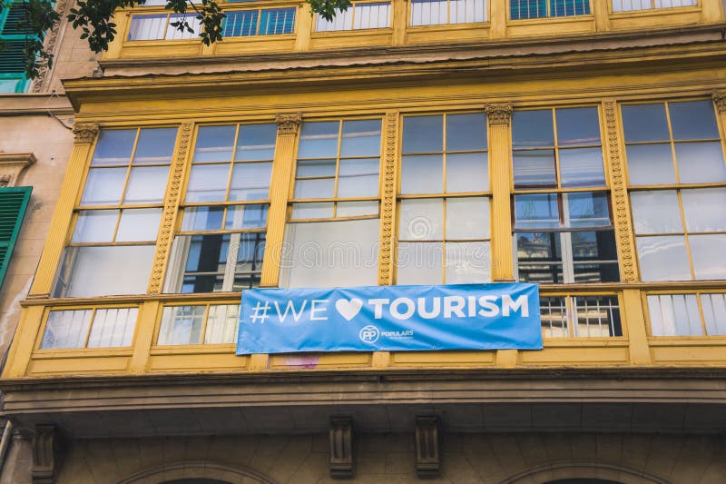 Pro-tourism banner `we love tourism` on a balcony in Palma de Mallorca, Balearic Islands, Spain royalty free stock photo Pro-tourism banner `we love tourism` on a balcony in Palma de Mallorca, Balearic Islands, Spain royalty free stock photo