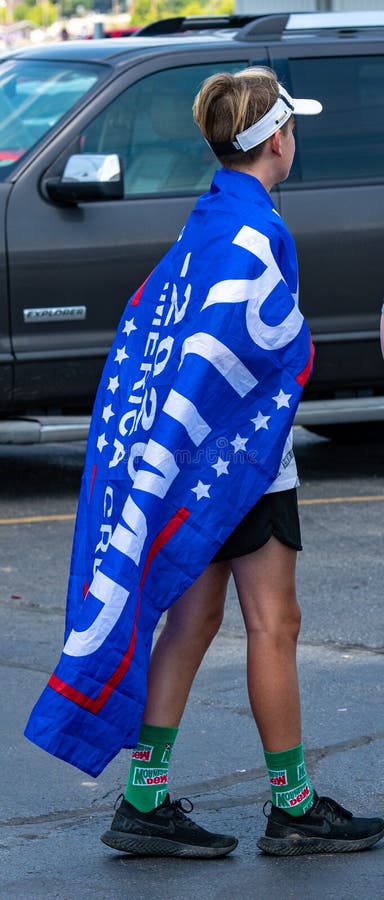 Pro Trump Boat Parade young man displays Trump 2020 No More Bullshit flag