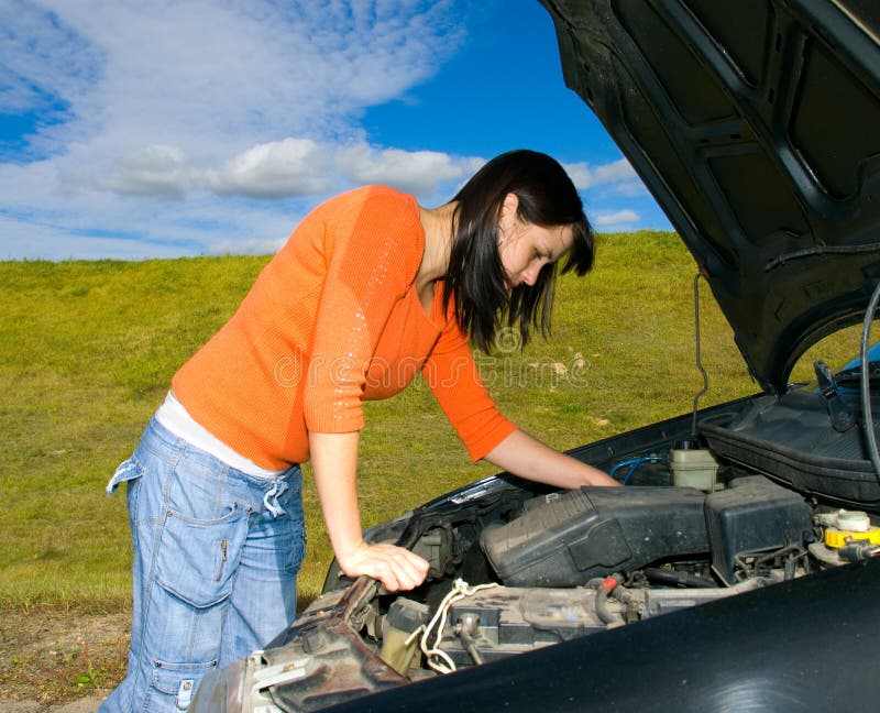 Woman repairing a motor vehicle. Woman repairing a motor vehicle