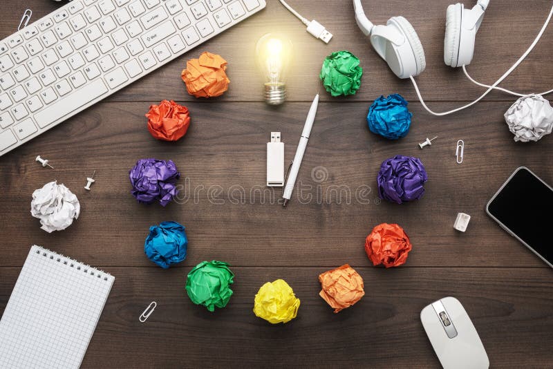 Top view of an office table with great idea concept. problem solution concept depicted by colorful crumpled paper and light bulb royalty free stock photo Top view of an office table with great idea concept. problem solution concept depicted by colorful crumpled paper and light bulb royalty free stock photo