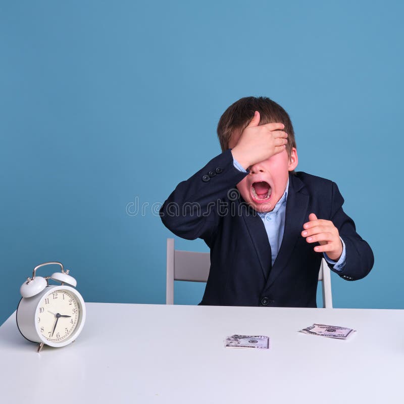 Problems with money at the boy junior schoolboy at school education stock photo