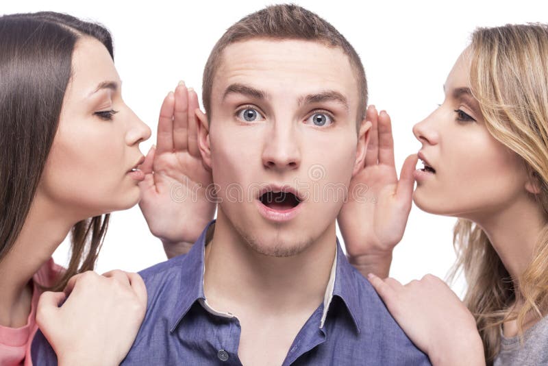 Close-up. Love triangle. Two young women talking to the man. isolated on white background. Close-up. Love triangle. Two young women talking to the man. isolated on white background.