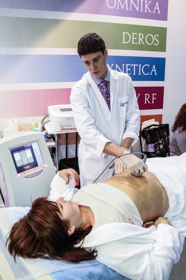 MOSCOW - OCTOBER 26: Procedure of vacuum massage at the international exhibition of professional cosmetics and beauty salon equipment INTERCHARM on October 26, 2011 in Moscow. MOSCOW - OCTOBER 26: Procedure of vacuum massage at the international exhibition of professional cosmetics and beauty salon equipment INTERCHARM on October 26, 2011 in Moscow