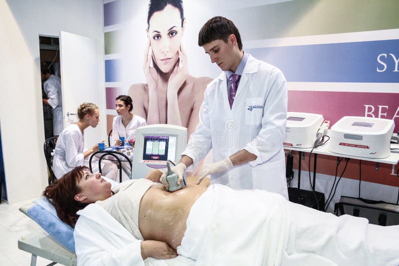 MOSCOW - OCTOBER 26: Procedure of vacuum massage at the international exhibition of professional cosmetics and beauty salon equipment INTERCHARM on October 26, 2011 in Moscow. MOSCOW - OCTOBER 26: Procedure of vacuum massage at the international exhibition of professional cosmetics and beauty salon equipment INTERCHARM on October 26, 2011 in Moscow