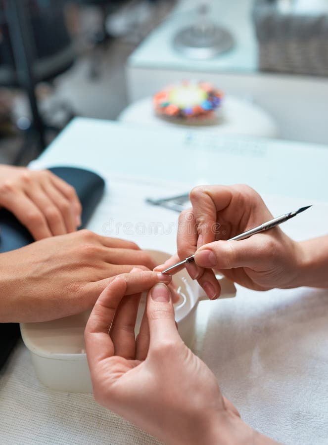 Procedure Cuticle Cutting the Nails, Client`s Hand and Manicure Stock
