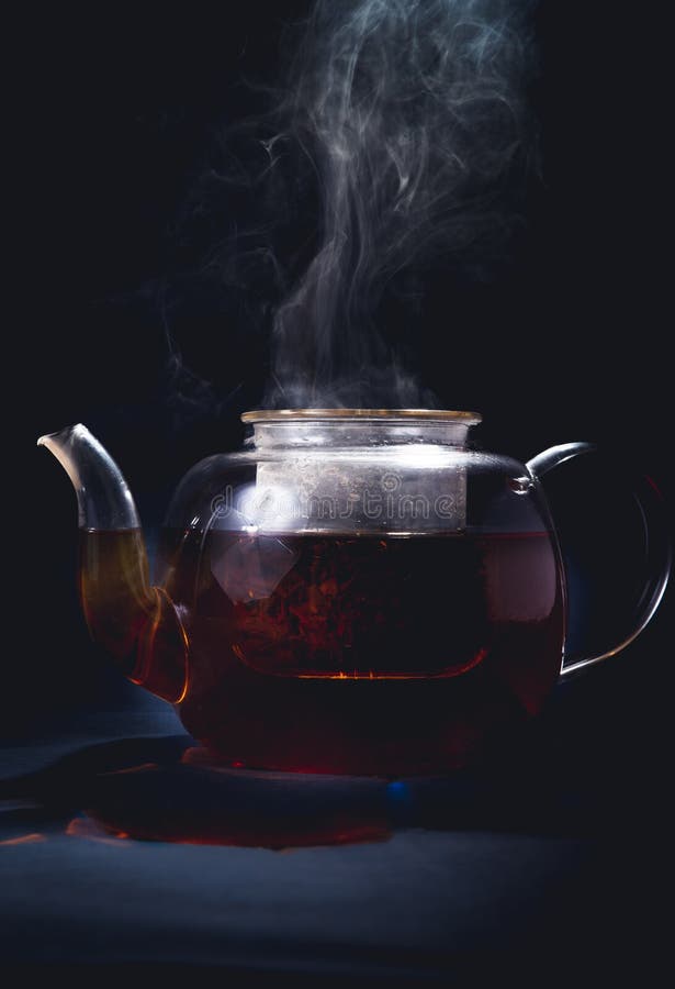 Process brewing tea,tea ceremony,Cup of freshly brewed black tea,warm soft light, darker background royalty free stock photography