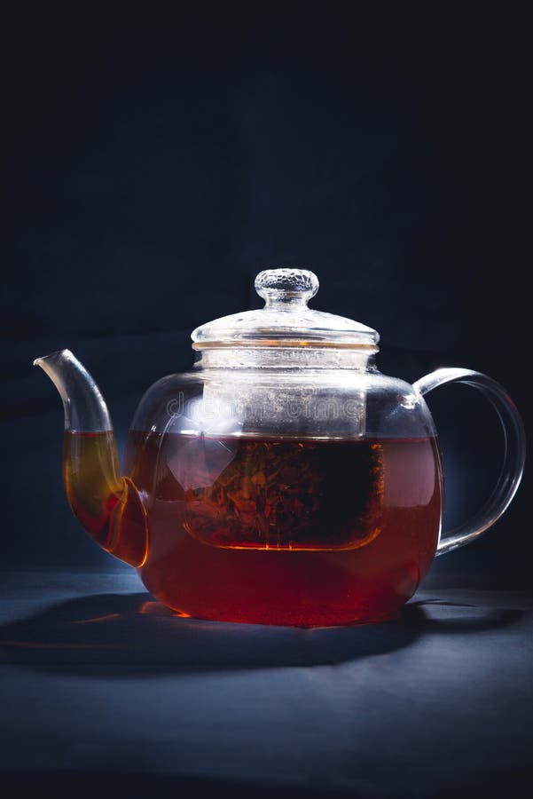 Process brewing tea,tea ceremony,Cup of freshly brewed black tea,warm soft light, darker background royalty free stock photography