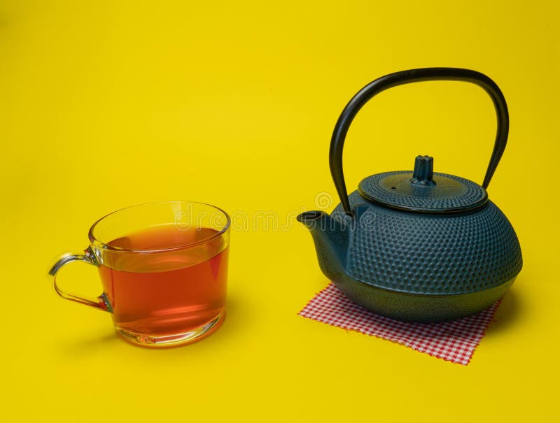Process brewing tea,tea ceremony,Cup of freshly brewed red tea,soft light, yellow background royalty free stock photography