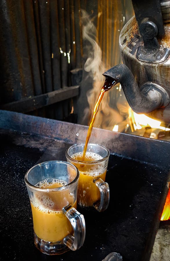 Process brewing tea, Cup of freshly brewed black tea. Pouring tea into the glass cup. The time of tea break. royalty free stock image